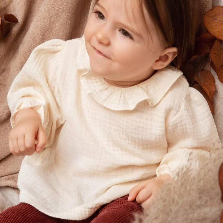 baby wearing premium European gauze blouse in ivory