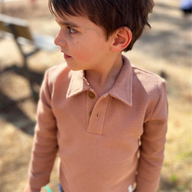 boy wearing premium European waffle polo shirt in old pink